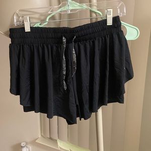 Flowy shorts with spandex layer underneath. Size XL. Never worn but no tags